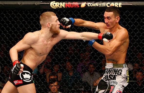 BOSTON, MA - AUGUST 17:  (L-R) Conor McGregor punches Max Holloway in their UFC featherweight bout at TD Garden on August 17, 2013 in Boston, Massachusetts. (Photo by Josh Hedges/Zuffa LLC/Zuffa LLC via Getty Images)