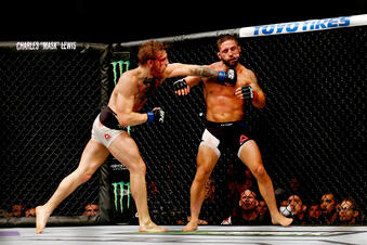 LAS VEGAS, NV - JULY 11: (L-R) Conor McGregor punches Chad Mendes in their UFC interim featherweight title fight during the UFC 189 event inside MGM Grand Garden Arena on July 11, 2015 in Las Vegas, Nevada. (Photo by Christian Petersen/Zuffa LLC/Zuffa LLC via Getty Images)